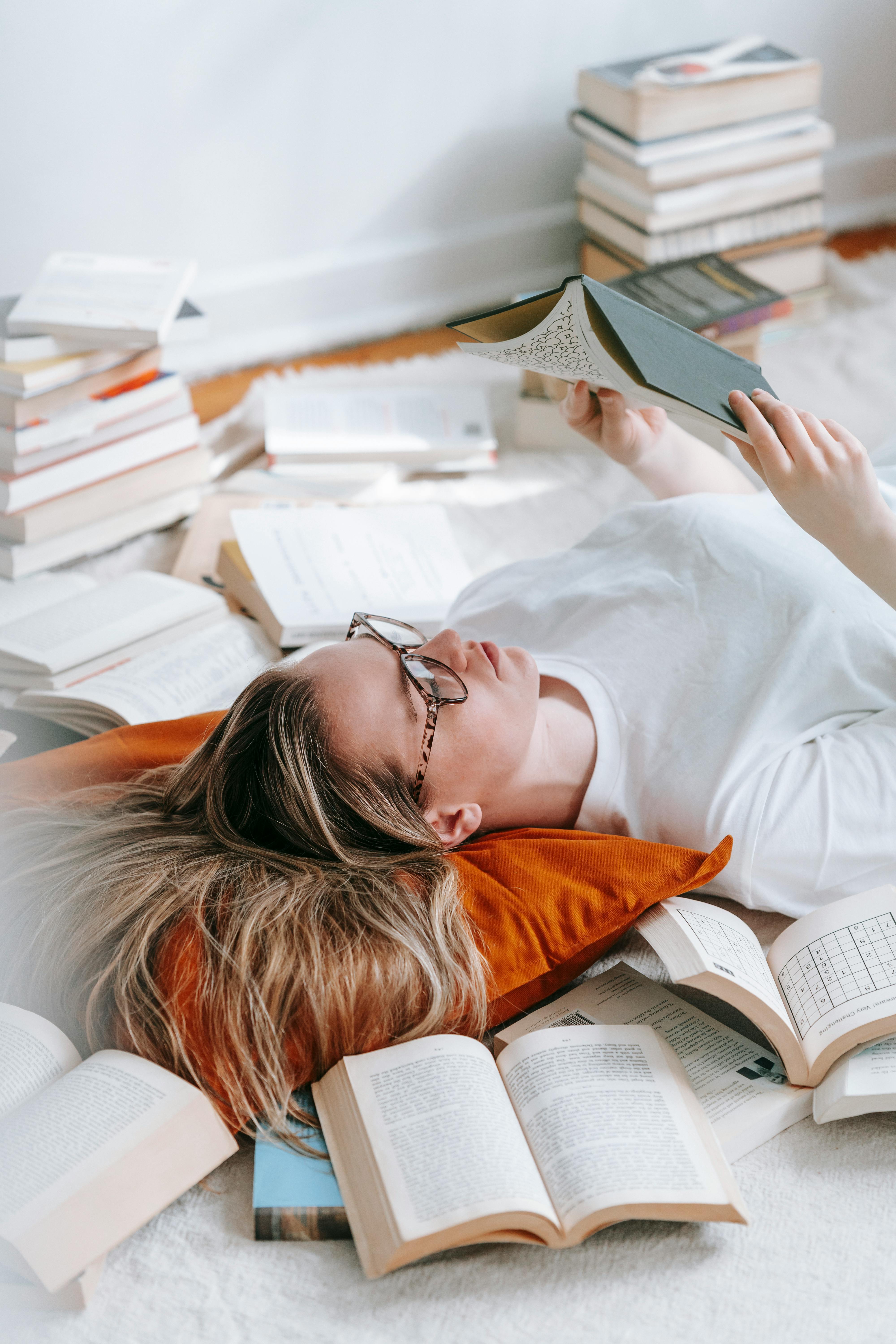 woman reading book amidst literature