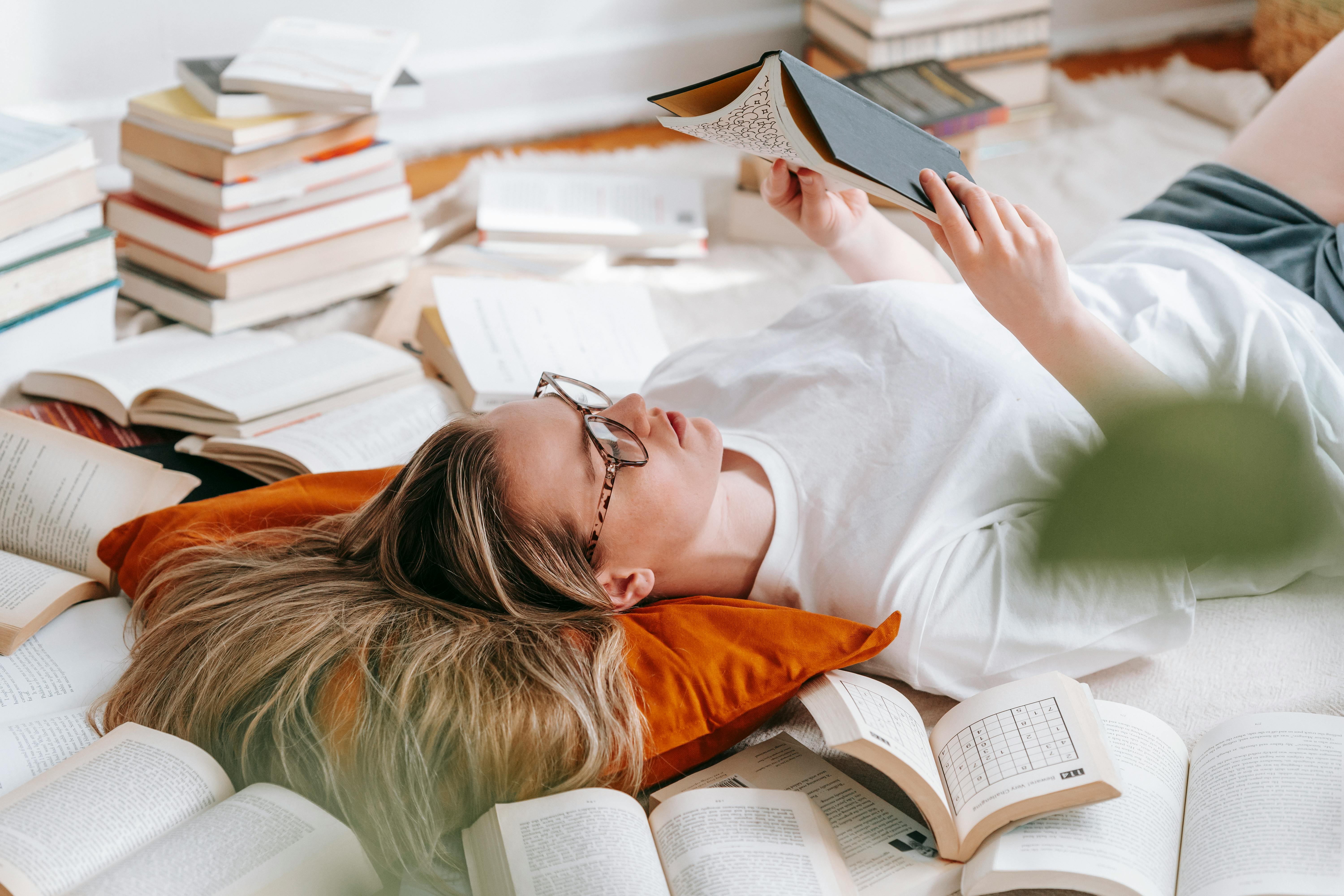 woman amidst heap of books