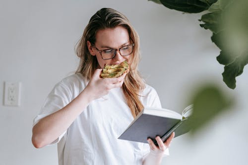 Young woman with book and toast