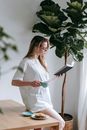 Woman immersed in book having breakfast