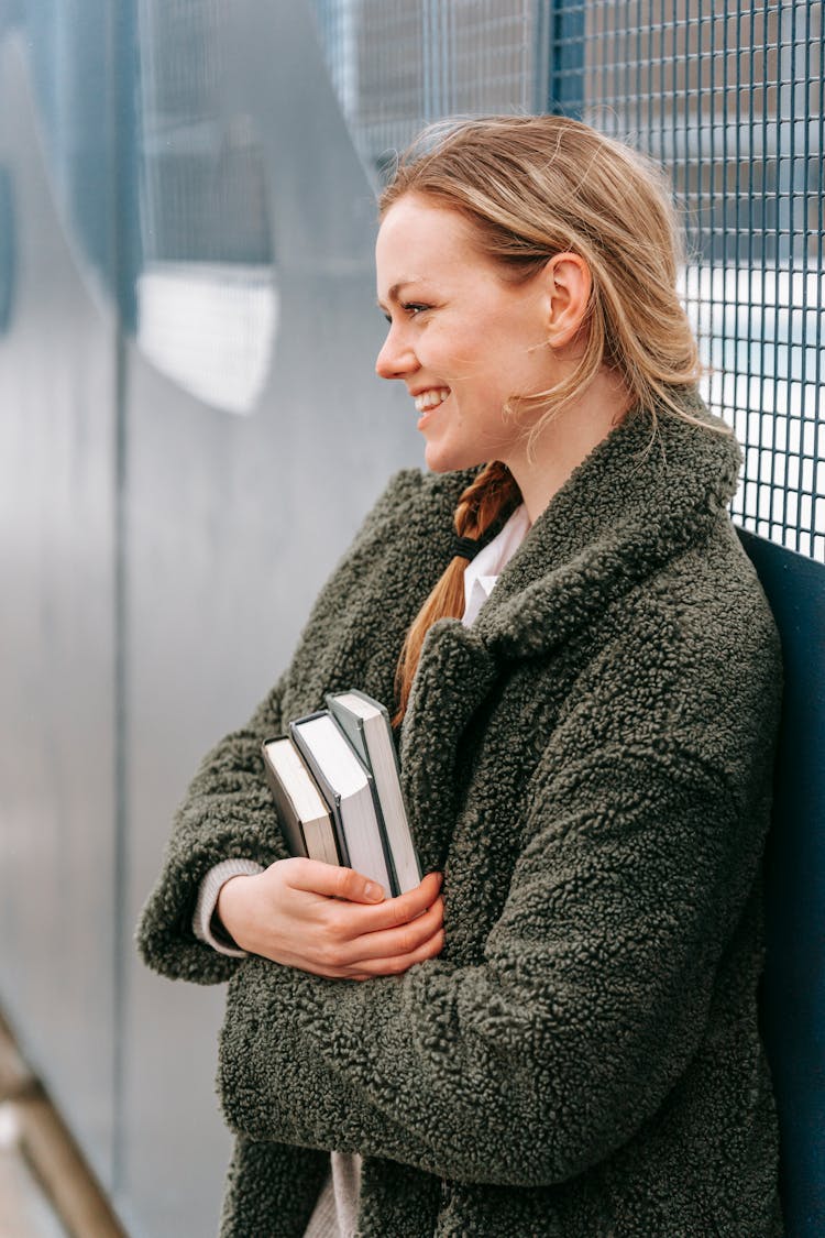 Young Woman With Pile Of Books