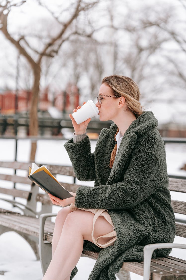 Student With Book Drinking Coffee In Winter Park