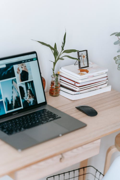 Laptop with photo gallery on table in room