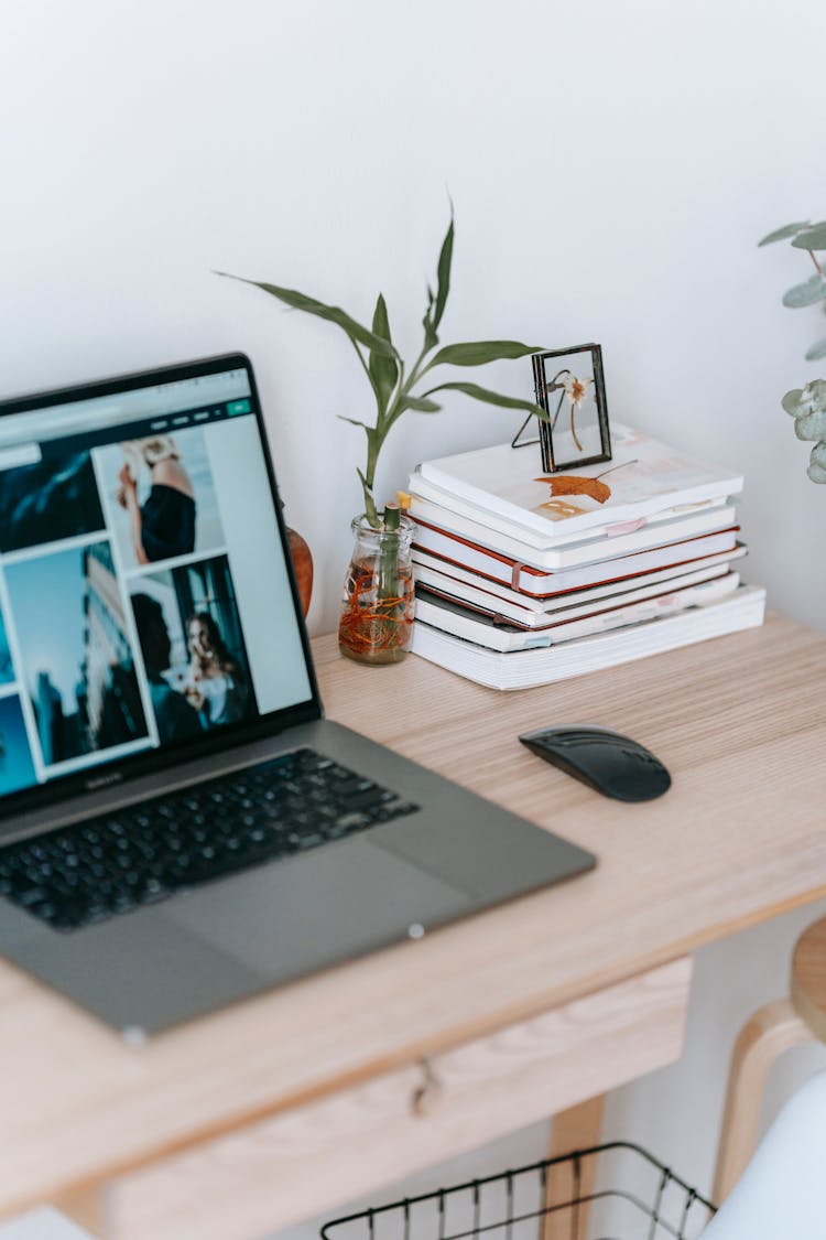 Laptop With Photo Gallery On Table In Room