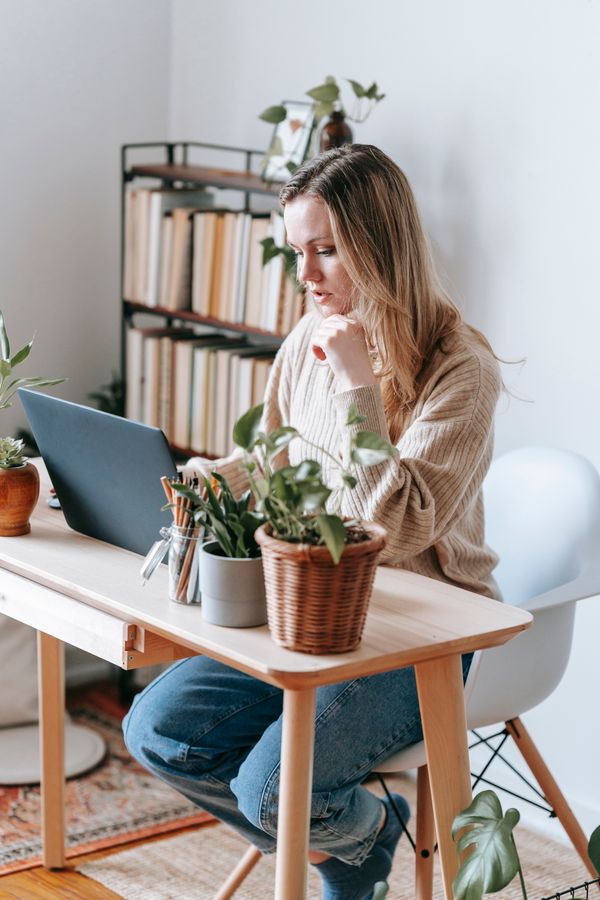 Woman in cream knit sweater elegant office outfit