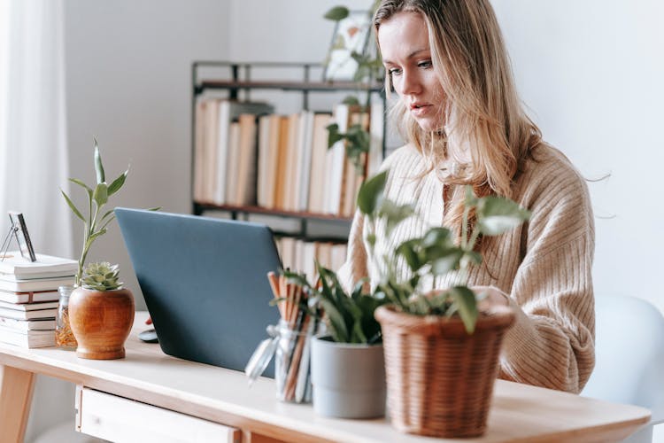 Crop Serious Freelancer Working On Laptop At Home Desk