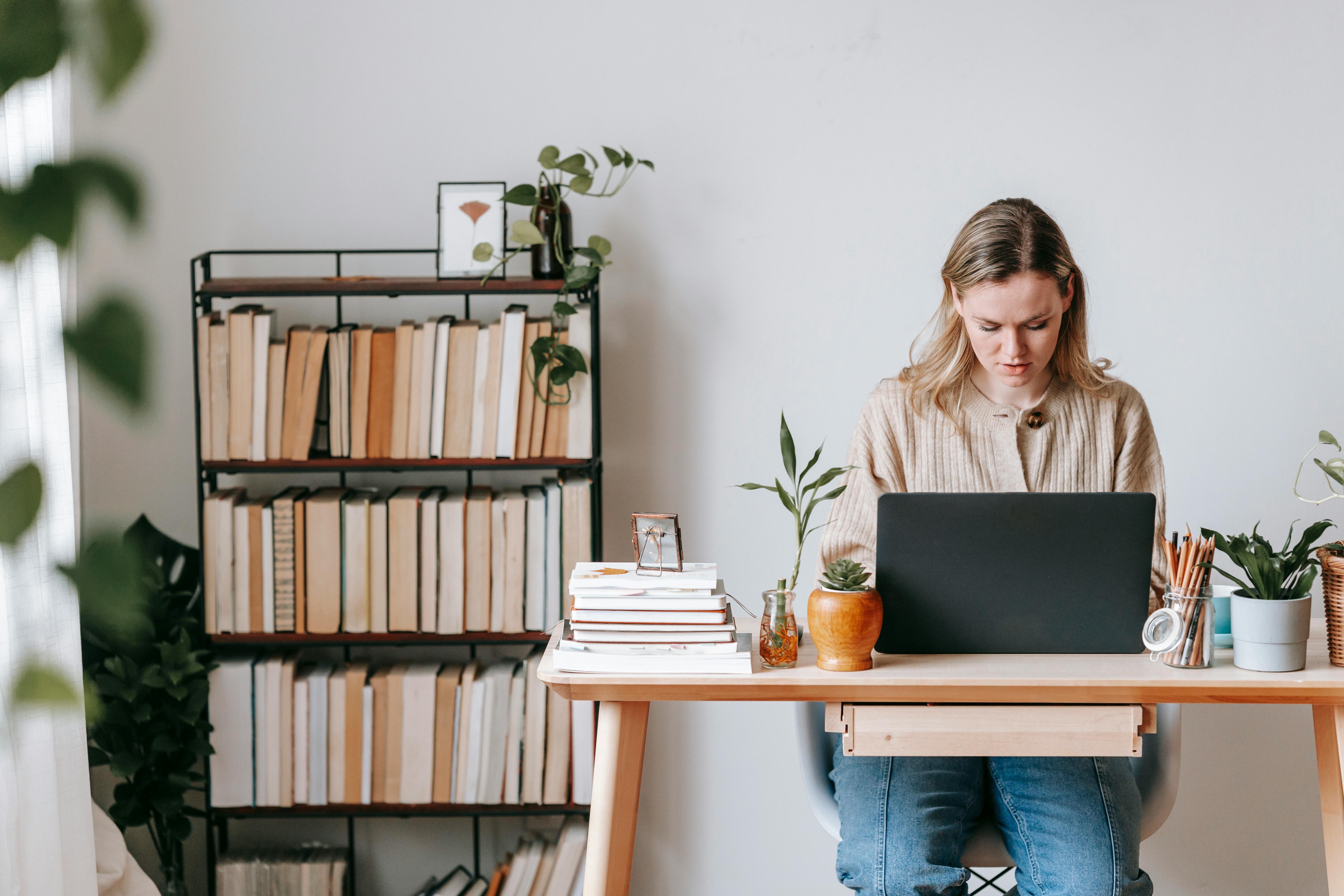 concentrated freelancer working on laptop at home desk