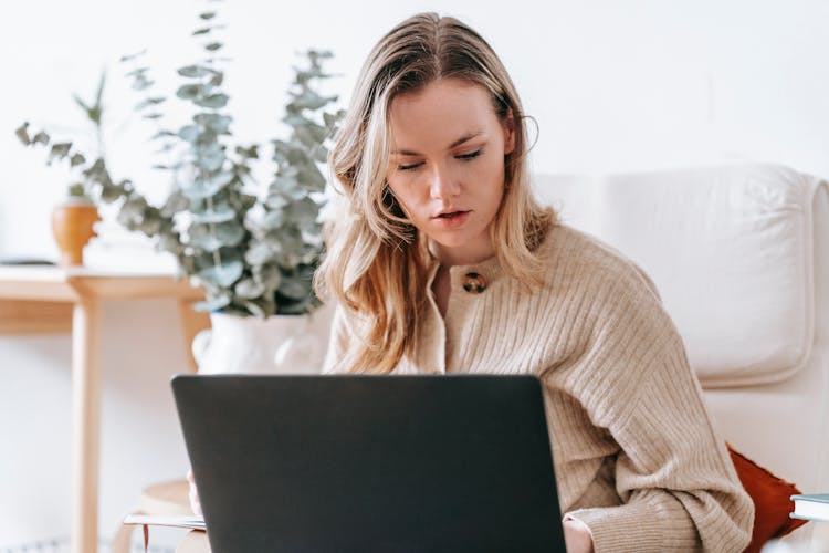 Busy Freelancer Working On Laptop At Home