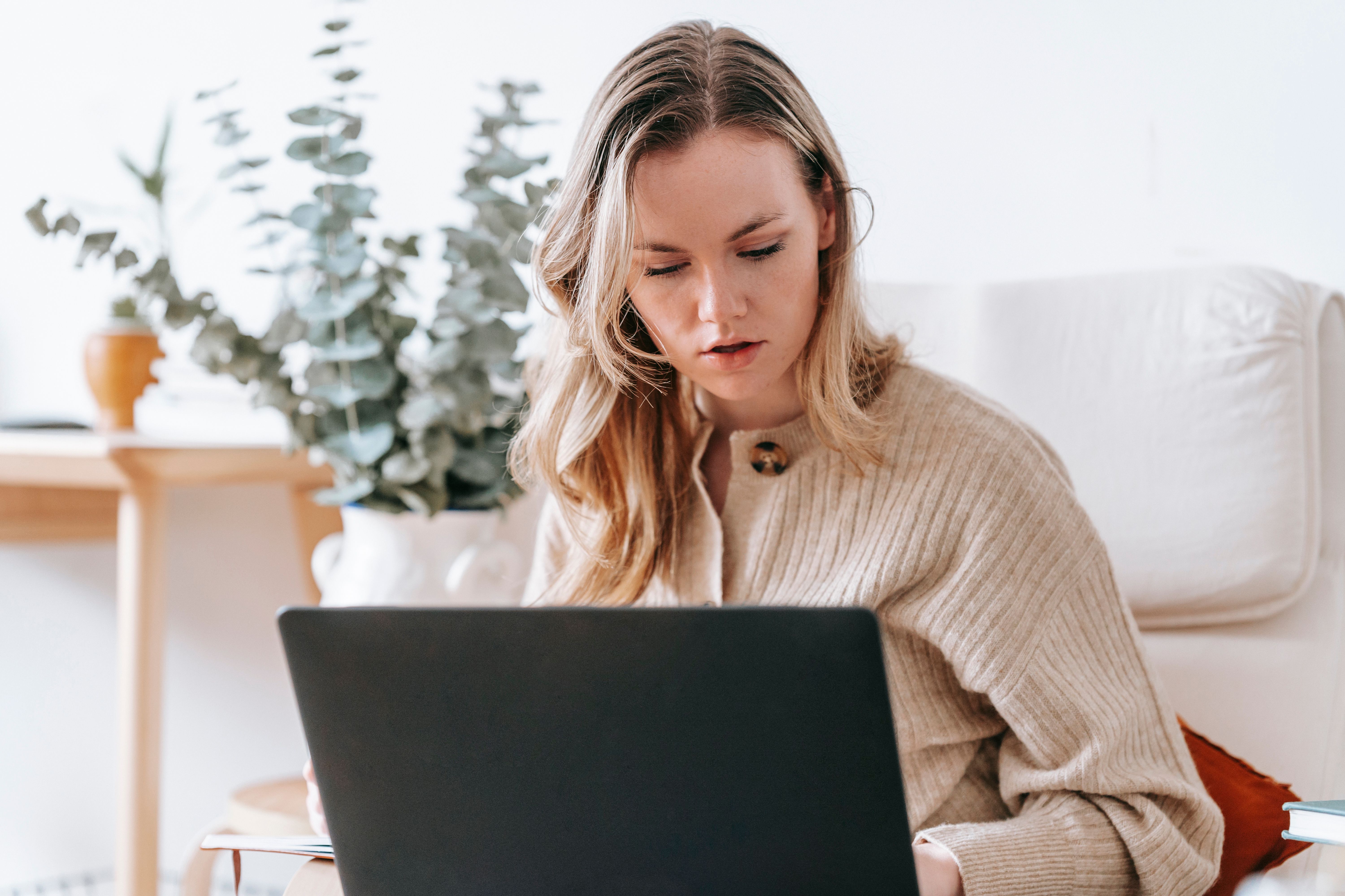 A freelancer working on a laptop at home with no external structure around them