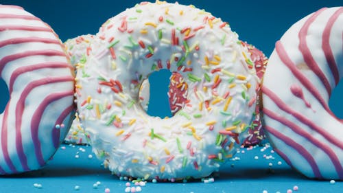 Close-Up Photo of Colorful Donuts on a Blue Surface