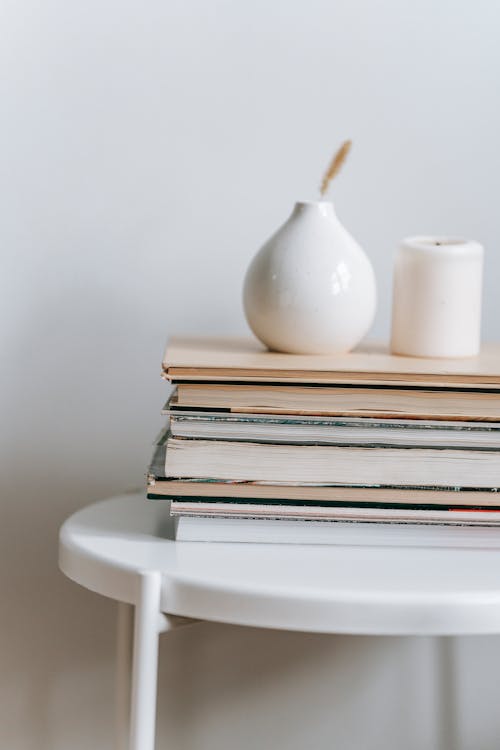 Free Ceramic Vases Placed on Stack of Books Stock Photo