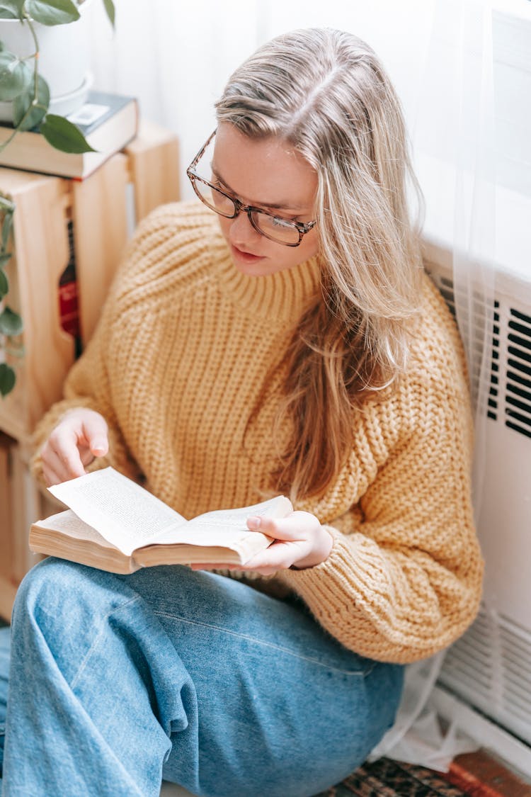 Young Woman Reading Book On Floor