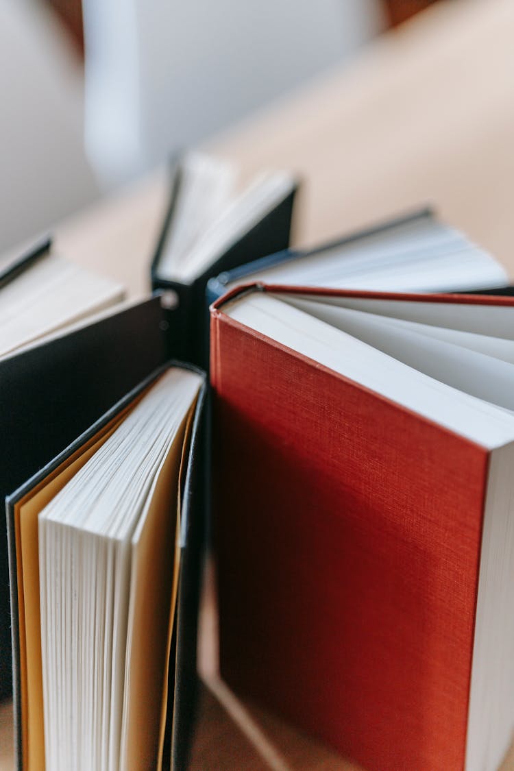 Book Volumes Placed On Wooden Table