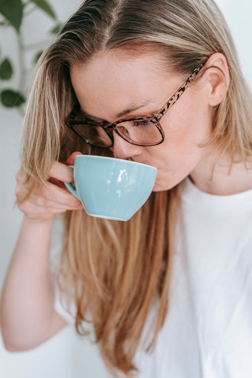 Free Woman drinking coffee in room Stock Photo