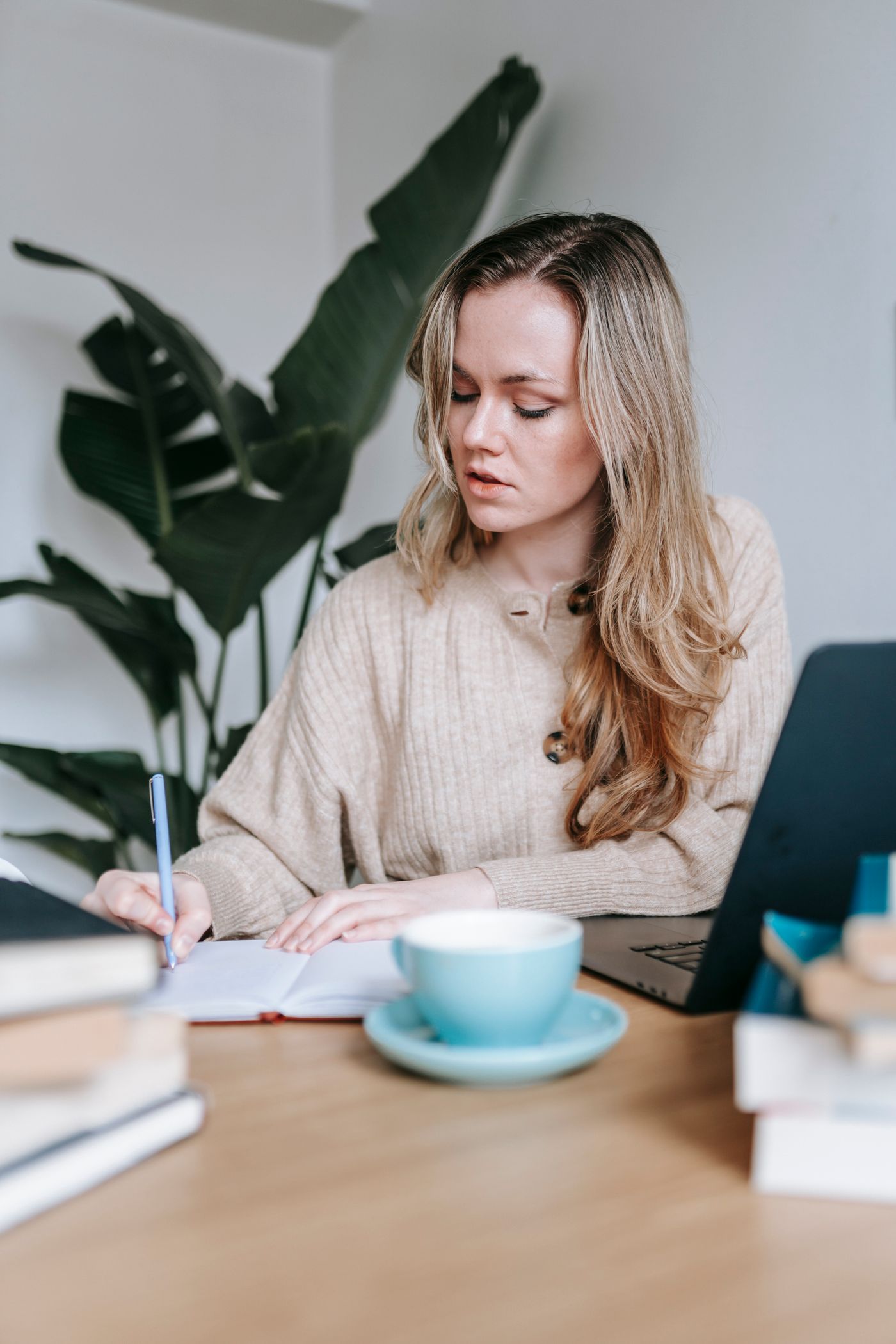 Writer taking notes at her desk