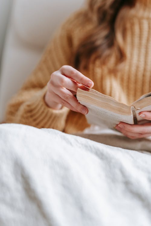 Free Close Up Photo of Person Reading Book  Stock Photo