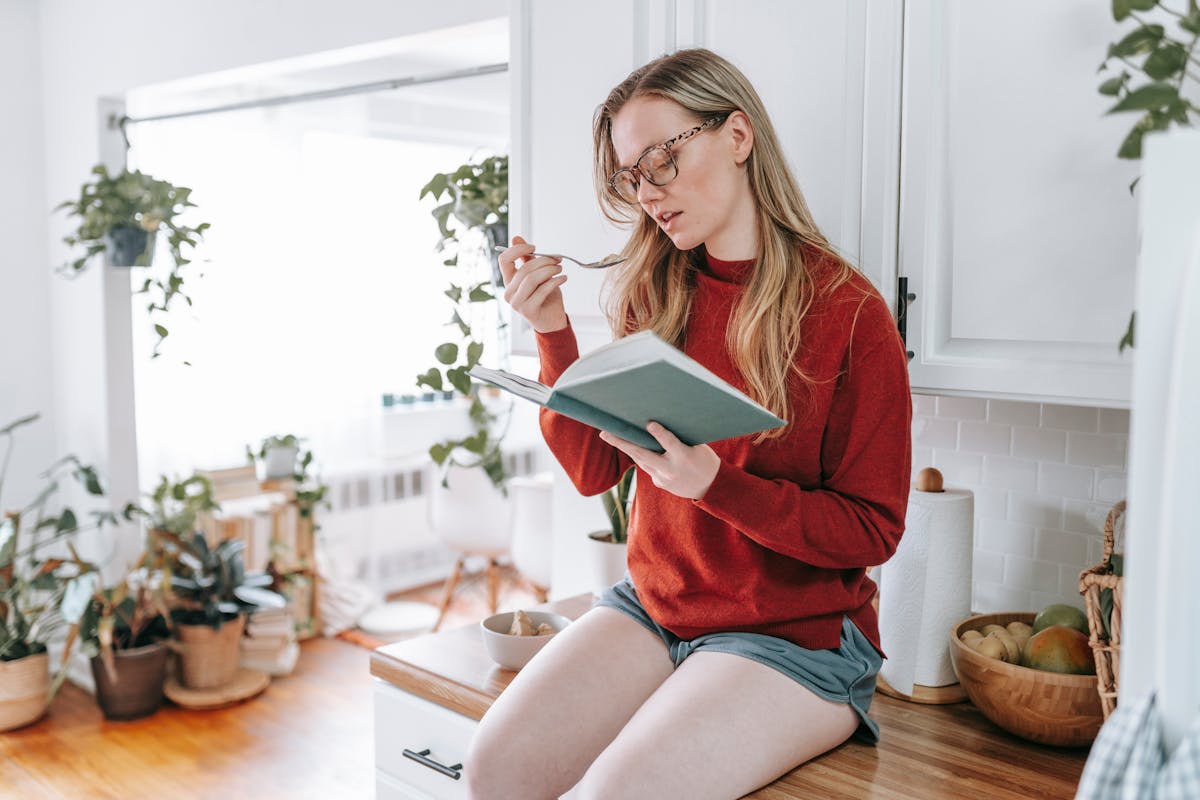 A Woman Eating Ice Cream while Reading