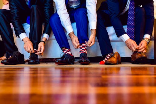 Men Tying their Leather Shoes