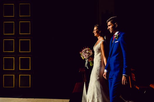 Bride and groom holding hands, walking into light, symbolizing love and unity.