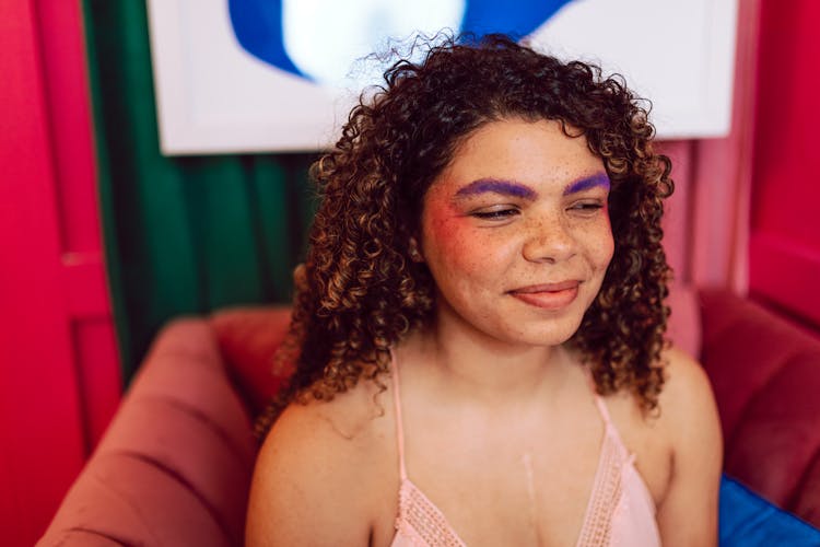 Woman With Curly Hair Wearing Purple Eyebrows