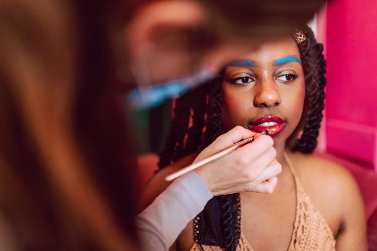 Woman With Blue Eyebrows And Red Lips