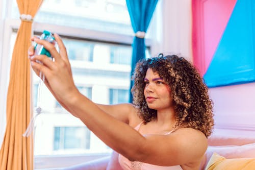 Woman with Curly Hair Taking a Selfie