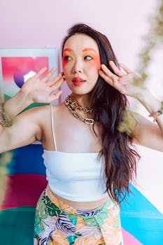 Vibrant portrait of a stylish woman with creative makeup and colorful background.