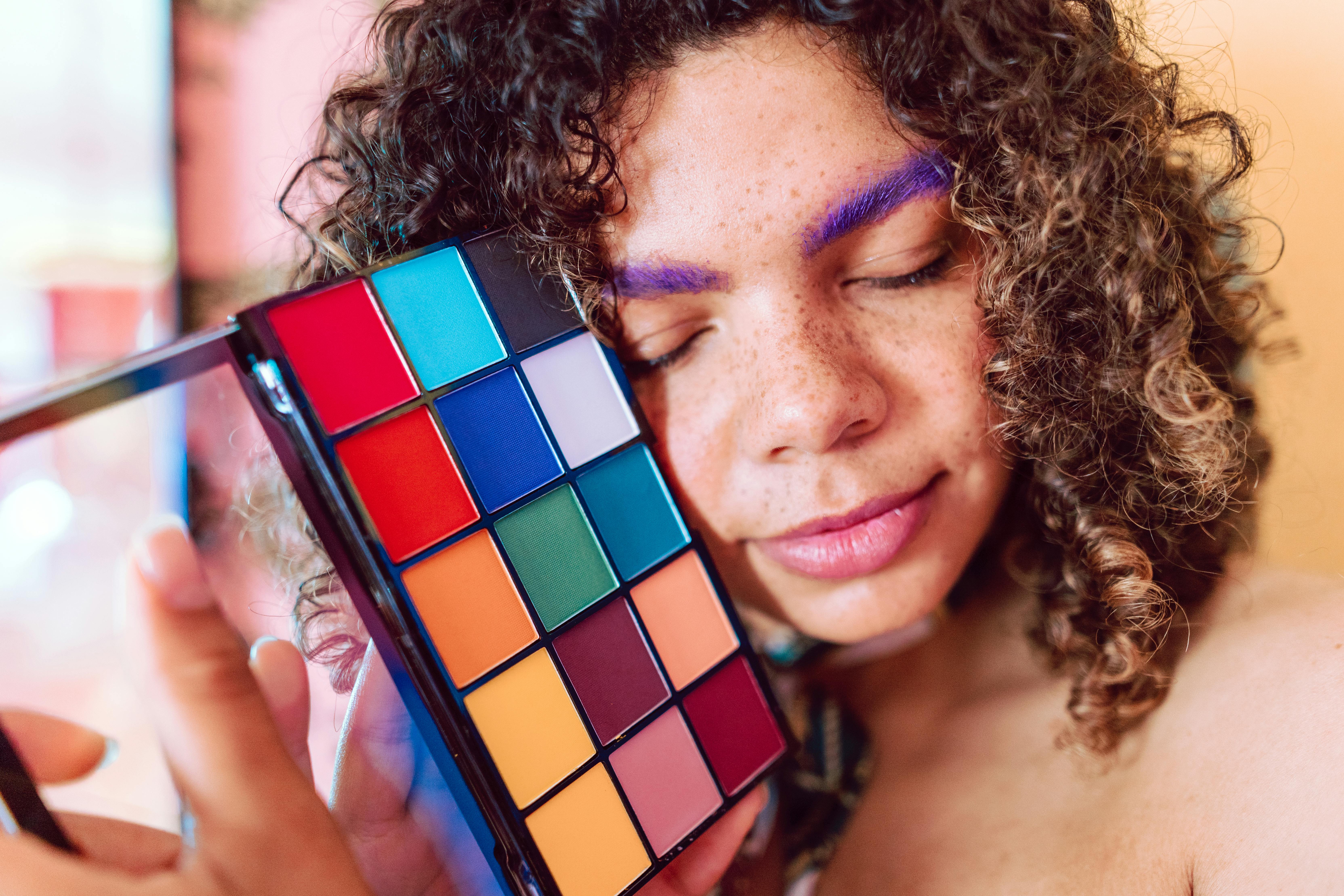 woman holding blue and red rubiks cube