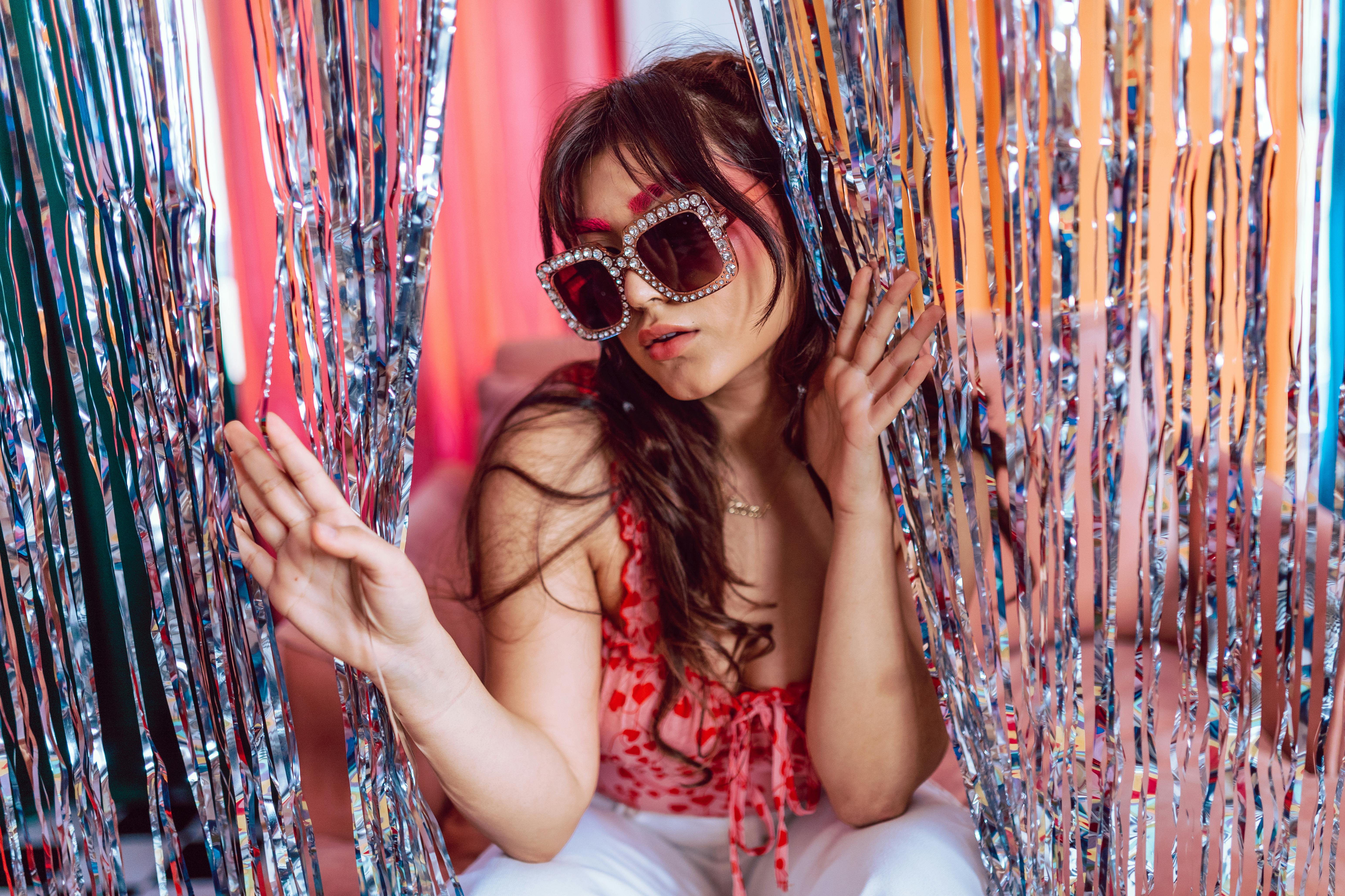 woman in white and red tank top wearing sunglasses