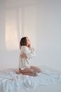 Lonely woman embracing body in morning