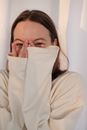Young woman laughing and covering face