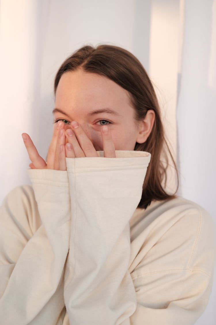 Young Female In Sweatshirt Laughing At Joke