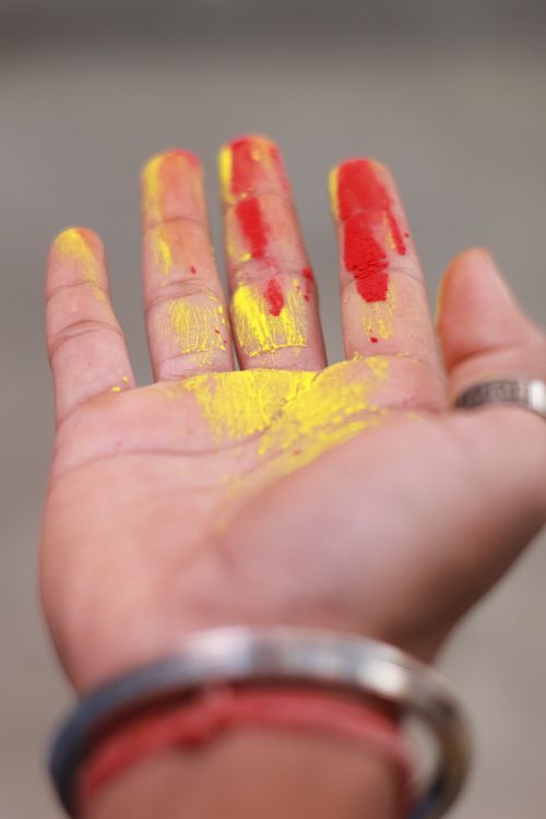 Free Close-up of a hand covered in vibrant Holi festival colors. Stock Photo