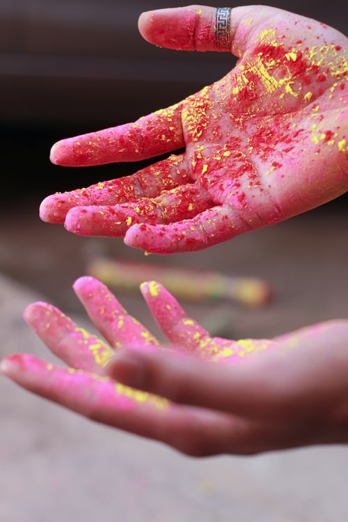 Free Close-up of hands covered in bright Holi powder during a festival celebration in India. Stock Photo