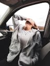 Woman Sitting in Car Leaning Head Back