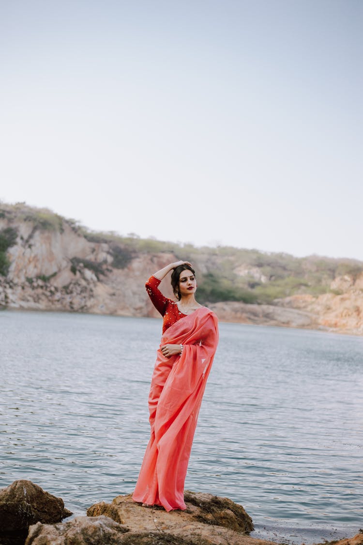 Graceful Ethnic Female Model In Indian Dress Standing On Stone