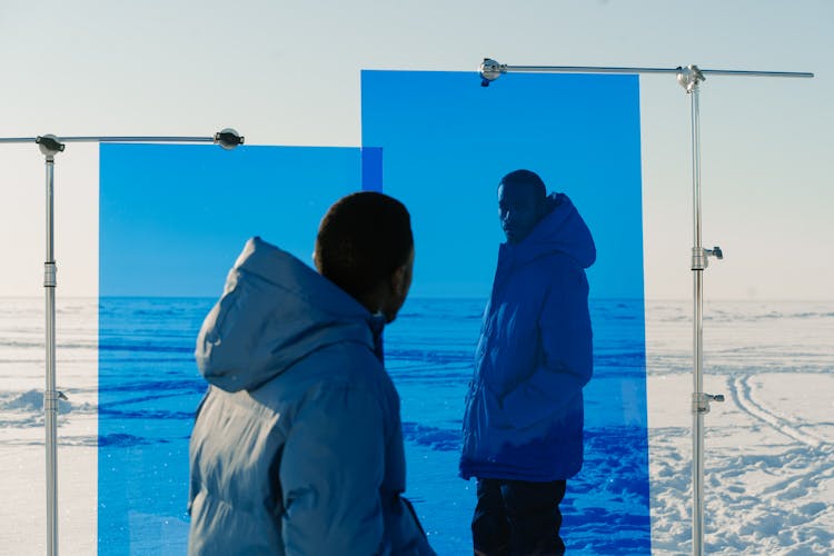 Men Wearing Blue Jackets In A Valley Covered With Snow 