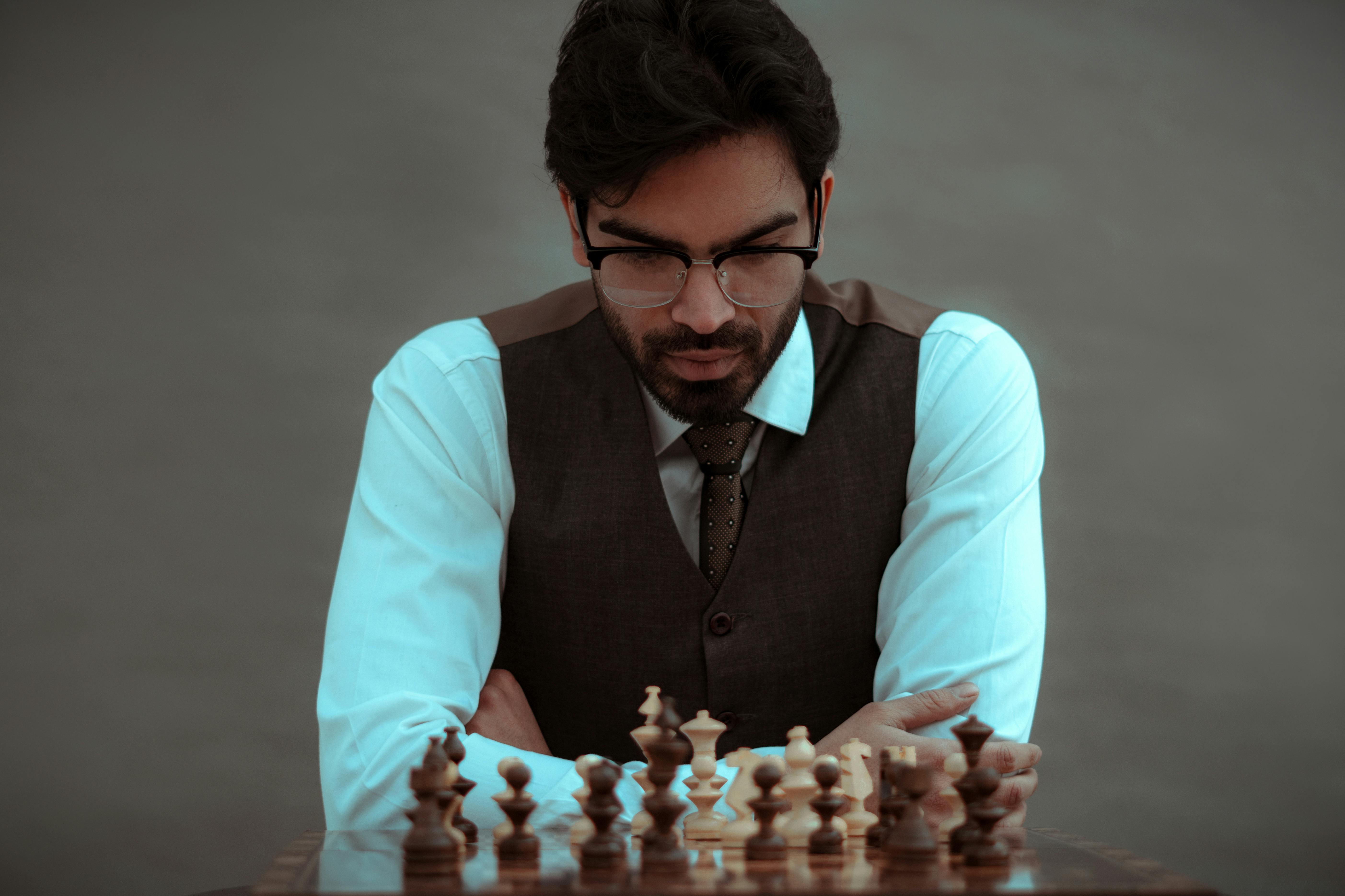 A Man Is Playing Chess Thinking About The Next Move Stock Photo - Download  Image Now - iStock