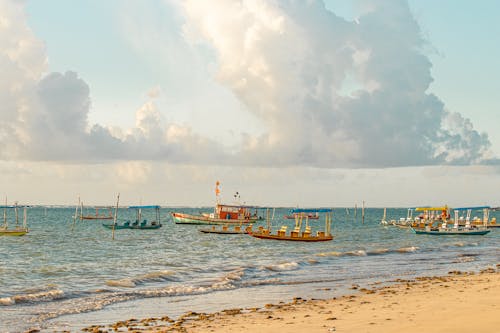 Boats Sailing on the Sea Under Cloudy Sky