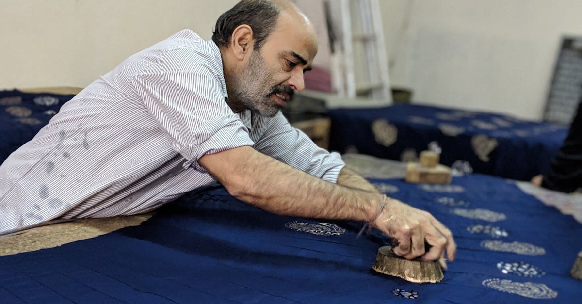 Elderly Man Cleaning Blue Rug · Free Stock Photo
