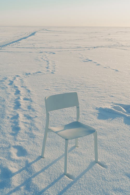 White Chair on a Snow Covered Ground