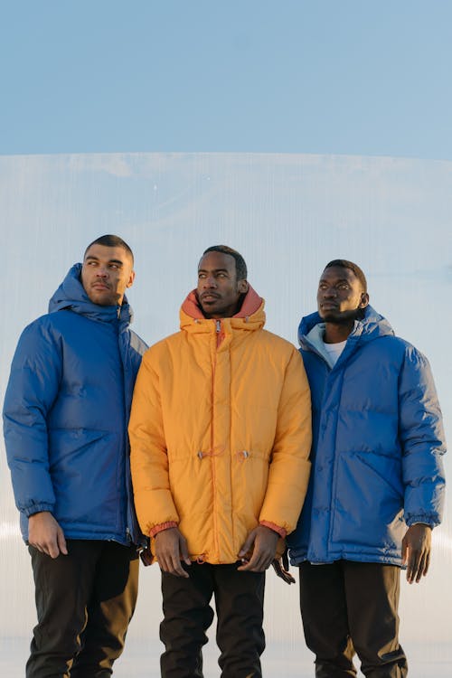 Models in Puffer Jacket Looking Afar Under Blue Sky