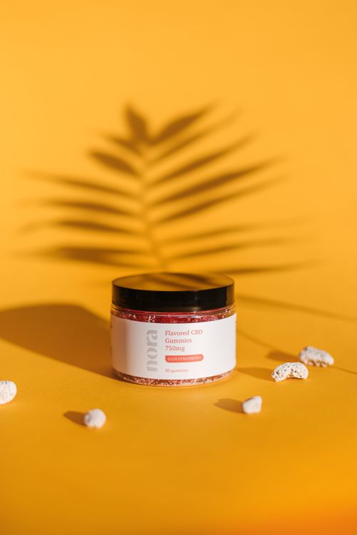 Free Cosmetic jar on a yellow background with a shadow of a palm leaf. Stock Photo