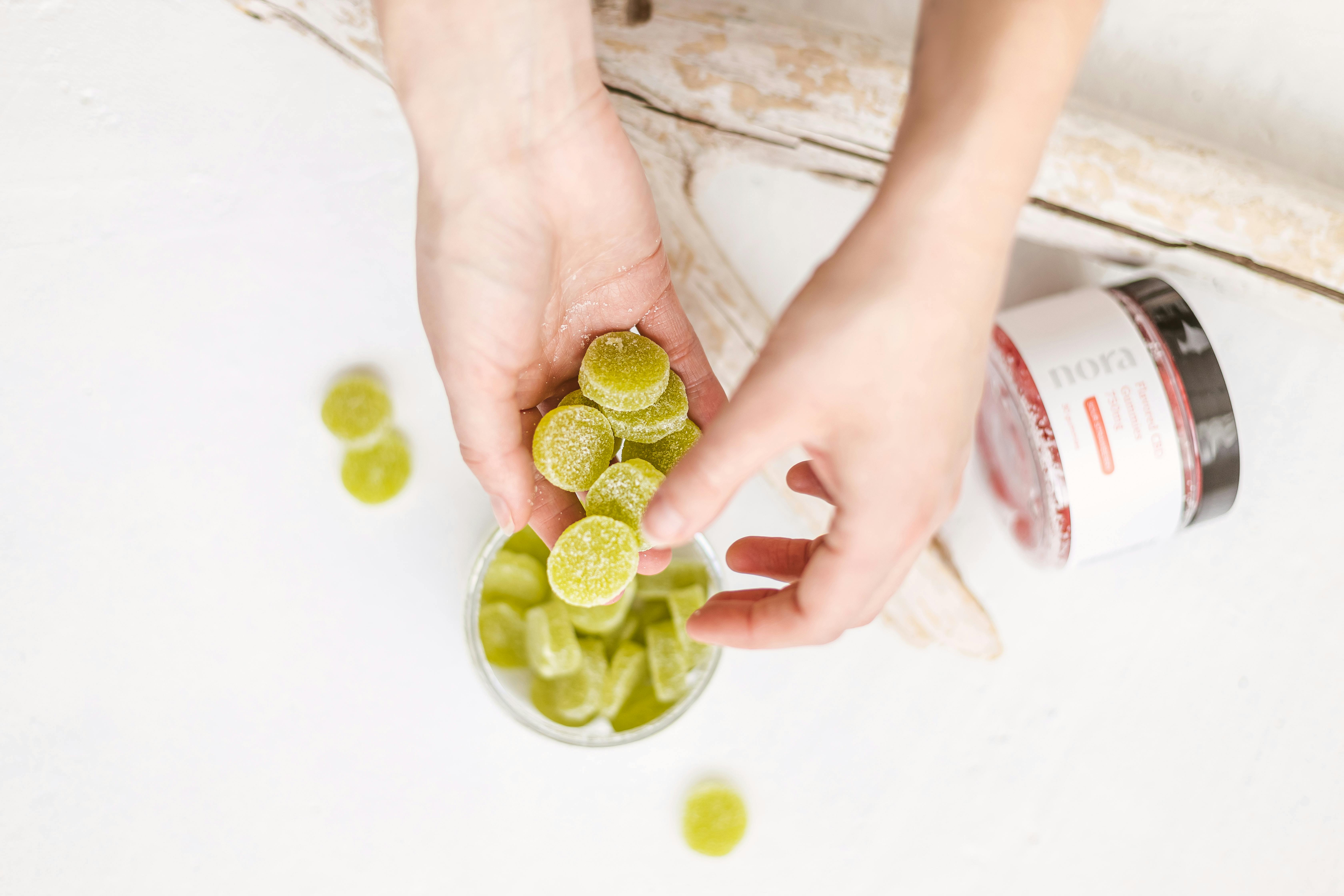 a person holding a handful a cbd oil food supplement