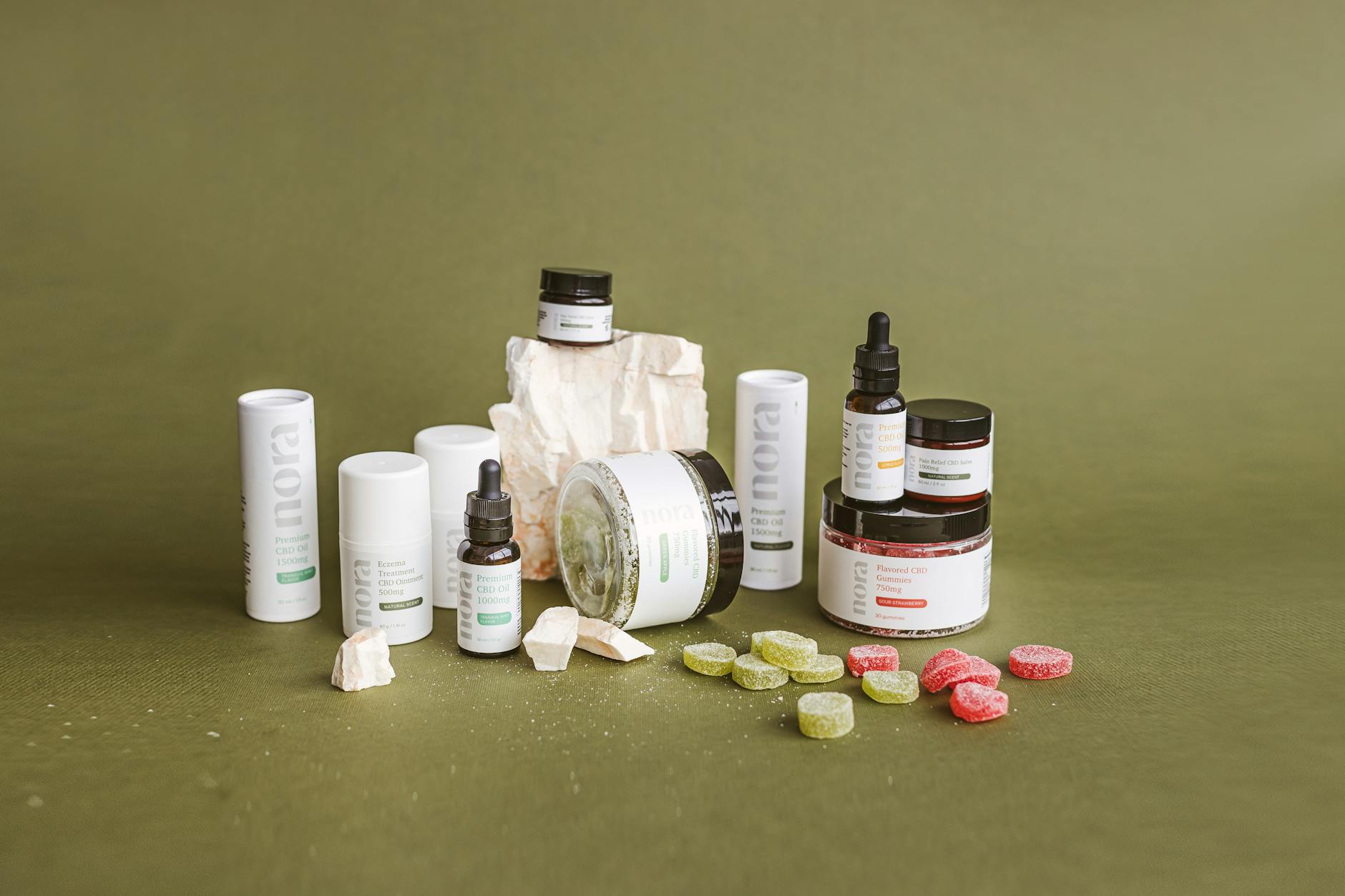 CBD skincare products arranged on a green surface showcasing eco-friendly beauty items.