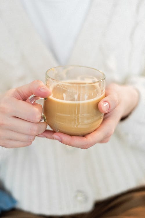 A Person Holding Clear Glass Cup of Coffee
