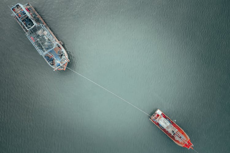 Barge And Boat With Fishing Nets On Rippling Water