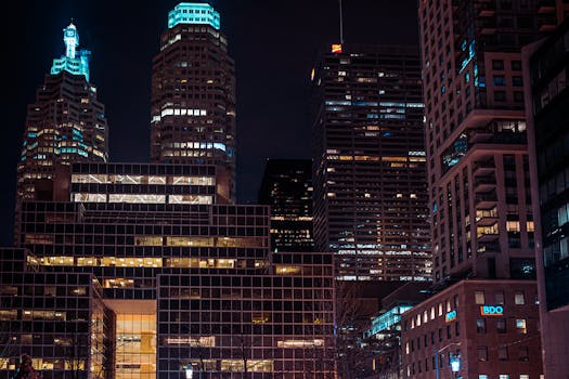 Nighttime view of Toronto's illuminated skyscrapers showcasing urban architecture.