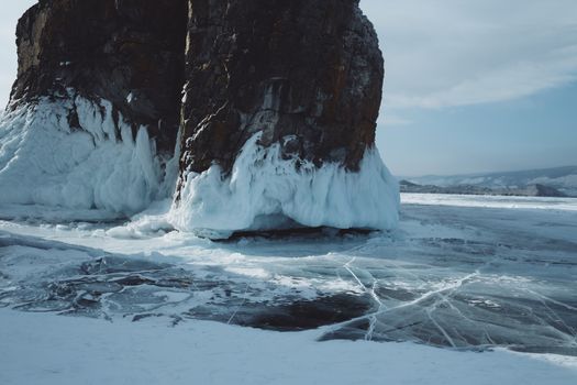 A stunning view of a frozen lake and icy rock formations during wintertime.