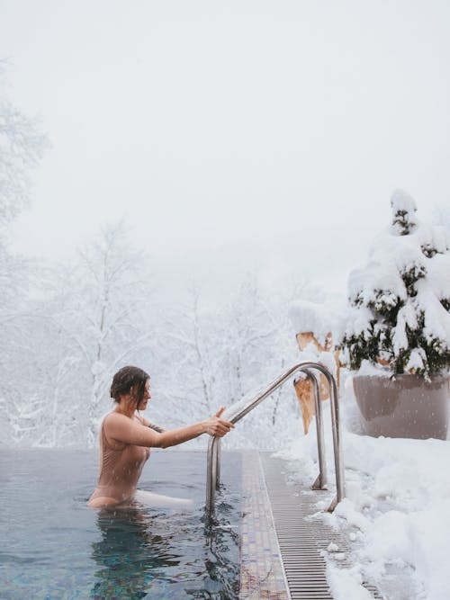 Woman Coming Out of the Outdoor Pool in Winter